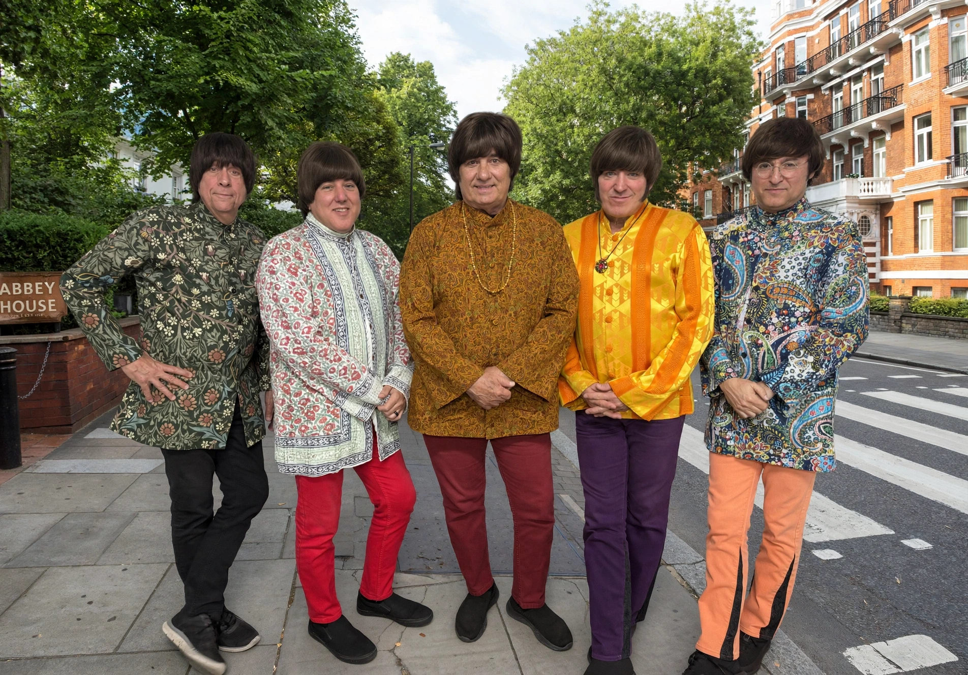 The Fab 5 standing near Abbey Road in colorful outfits