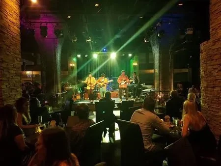 Fab 5 performing at a nightclub with stage lighting