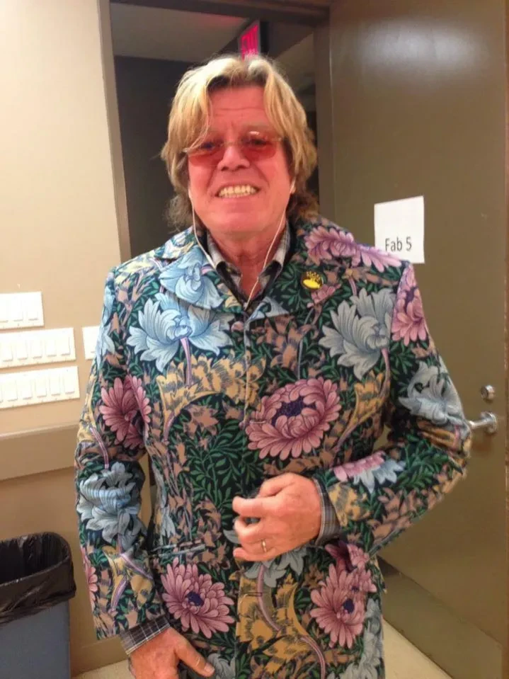 Fab 5 band member in floral jacket backstage