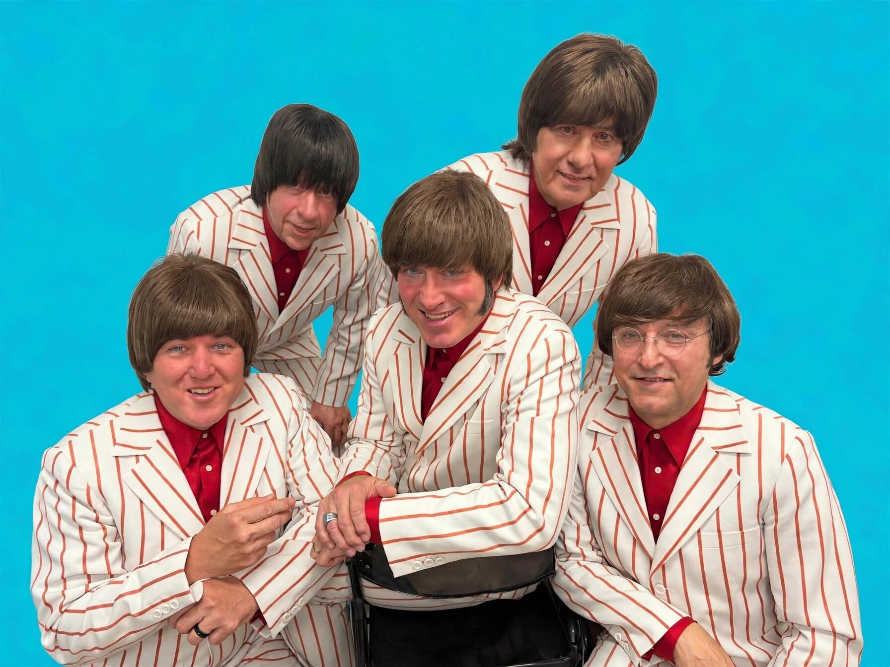 The Fab 5 in red and white pinstriped blazers against turquoise background