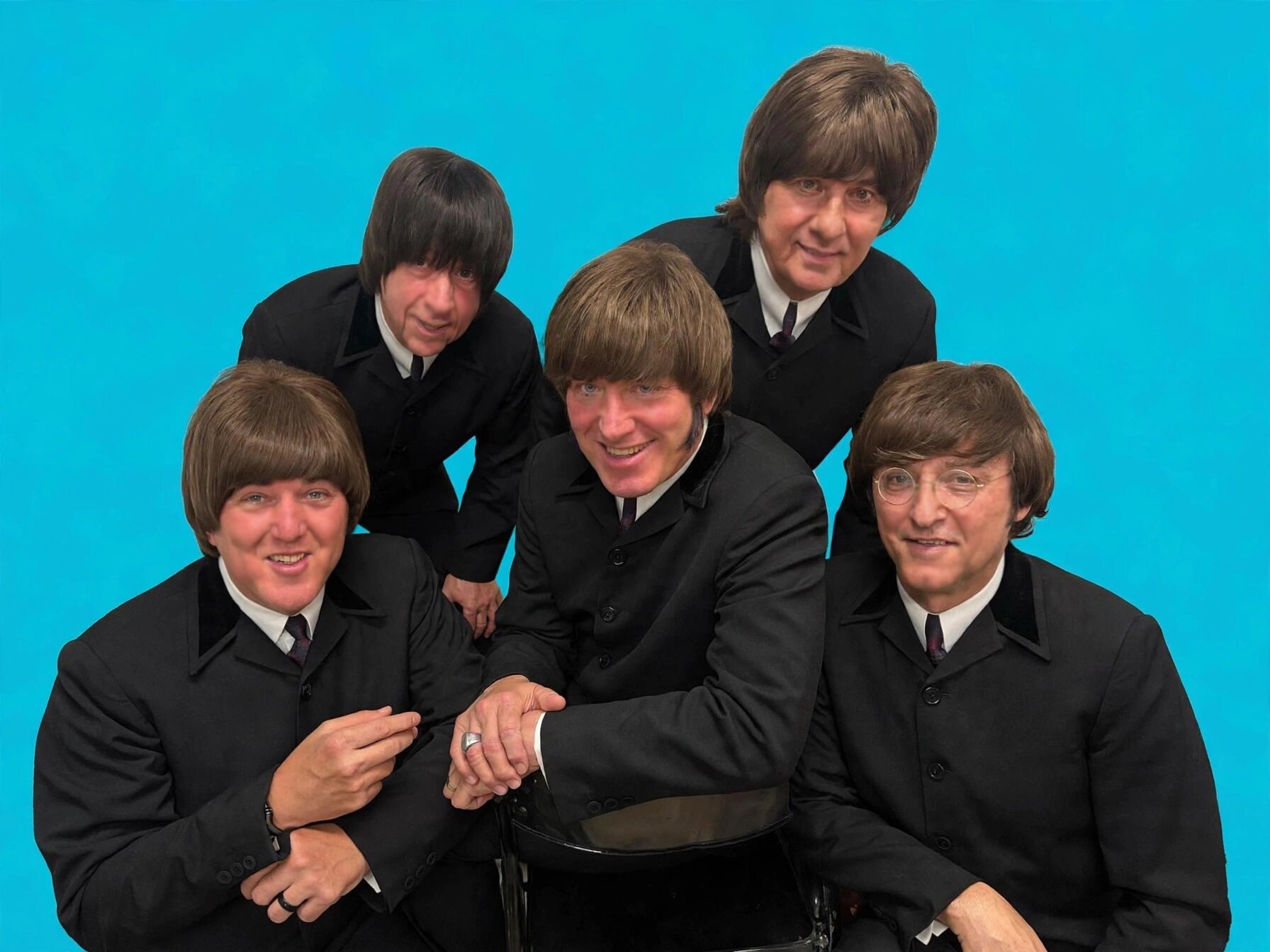 The Fab 5 in black suits against turquoise background