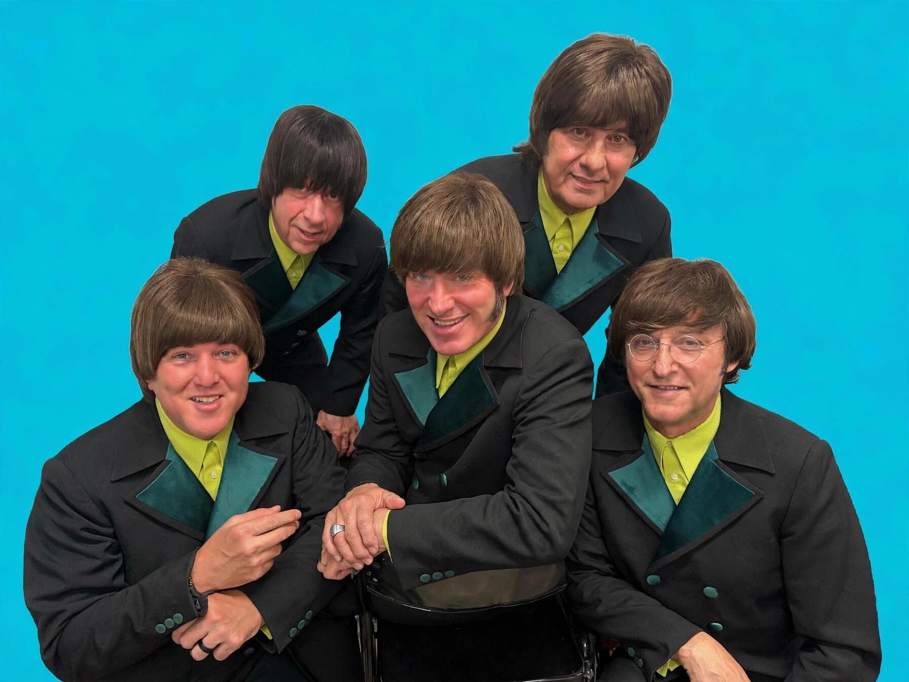 The Fab 5 in black jackets with lime green shirts against turquoise background