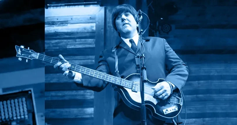 Fab 5 bassist performing on stage with blue tint lighting