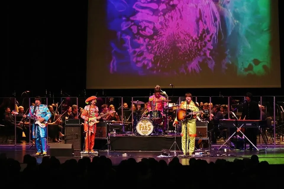 Fab 5 in Sgt. Pepper costumes performing with orchestra